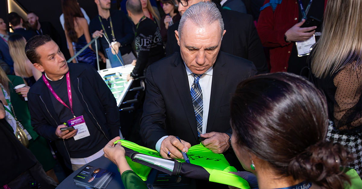 Stoichkov - In 2025, ICE was held in Barcelona for the first time, attracting more than 55,000 visitors. Celebrated for its creativity, innovation, and deep passion for football and gaming, the city provided the ideal setting for an unforgettable event. A key moment at Amusnet’s stand was the exclusive participation of football legend, Barcelona icon, and official company partner Hristo Stoichkov. The collaboration with the leading all-casino solutions provider was officially announced in July 2024. It brings the excitement of football - one of the world’s most beloved sports, to a global audience while reinforcing the company’s commitment to delivering exceptional gaming experiences. The partnership with Stoichkov, a football legend ranked among the 100 greatest players of all time, strengthens Amusnet’s leadership in the gaming industry. It embodies core values like teamwork and determination, driving the company’s success and innovation. The exclusive appearance of FC Barcelona legend Hristo Stoichkov at ICE drew thousands of visitors who seized the unique opportunity to meet him. In the city that played a pivotal role in his career, Stoichkov brought value to the global gaming community, further strengthening Amusnet’s dedication to world-class entertainment. Hundreds of attendees showcased their competitive spirit in a thrilling foosball championship, competing for exclusive prizes, including autographed footballs signed by Stoichkov and 2025 Champions League tickets. Adding to the anticipation, the iconic player personally drew the winners, making the moment even more unforgettable. The Amusnet team was also honored to welcome Digitain’s founder, Vardges Vardanyan, alongside Real Madrid Legends: Michel Salgado, Michael Owen, Iker Casillas, and Luis Figo, to its stand. The presence of these iconic football stars, alongside Hristo Stoichkov, embodied the spirit of collaboration and innovation, reinforcing the concept of industry pioneers uniting to shape the future of gaming. Visitors at the Amusnet stand had the chance to experience the celebrity slot game Stoichkov #8, launched ahead of UEFA EURO 2024 to heighten the tournament's excitement. Inspired by Stoichkov’s legendary career, the game captures the essence of football with immersive graphics and dynamic features, bringing the thrill of real matches to the reels through Free Spins, Buy Bonus, and Expanding Wilds for continuous action. Recognized for its excellence, Stoichkov #8 received the Online Game of the Year award at the BEGE Awards 2024. Since its debut, it has become a player-favorite across multiple markets in Europe and LATAM. The all-casino solution provider expanded the gaming experience for land-based players with the launch of its Type S slot machines in 2024 and the world premiere of the state-of-the-art J 55 at ICE Barcelona 2025. Powered by the AmuseBox platform, players can enjoy 52 titles, including Stoichkov #8, like never before. Featuring a 55-inch curved main display, premium design, and high-end finishings, the latest slot cabinet offers a new level of immersion and engagement. Following the success of ICE Barcelona 2025, Amusnet remains dedicated to further developing its partnership with Hristo Stoichkov. As this collaboration evolves, fans and players can look forward to even more iconic moments from his legendary career brought to life through Amusnet’s innovative gaming releases.
