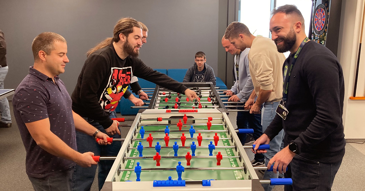 7 young men internship applicants playing football at the Amusnet office